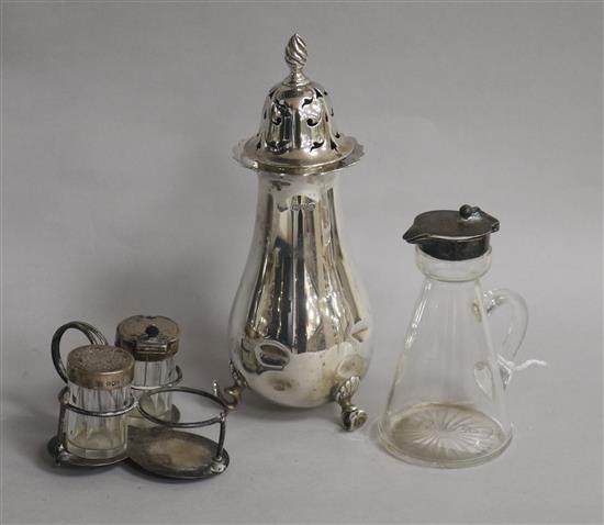 A George V silver mounted whisky tot, a silver sugar caster and a part condiment set.